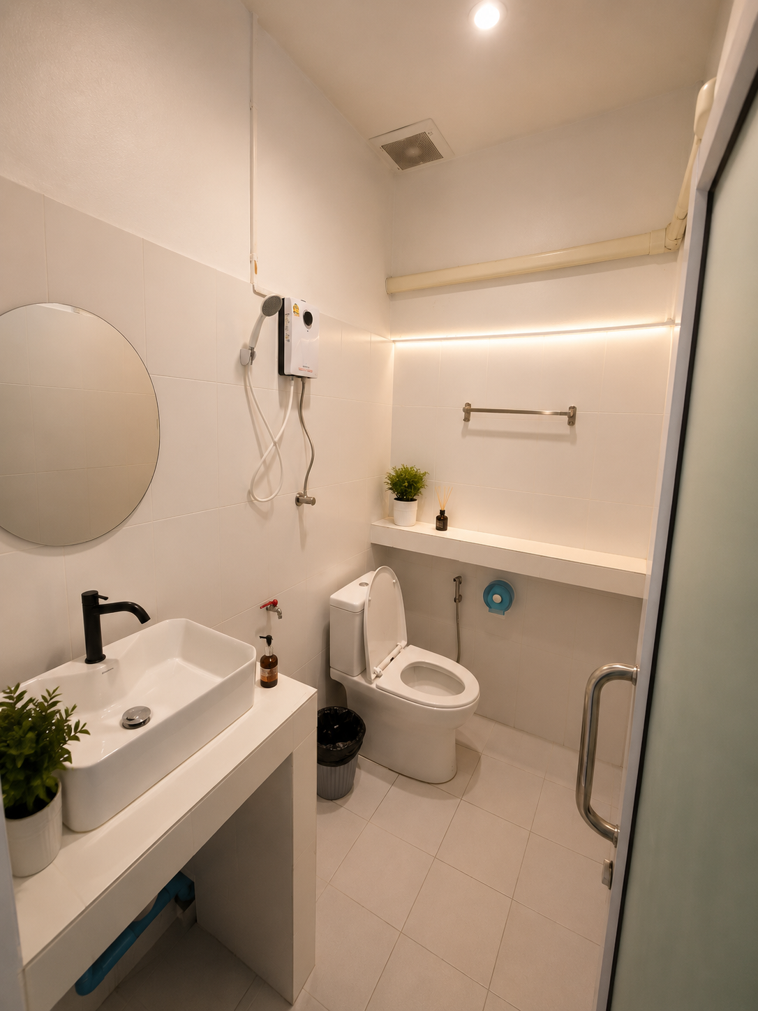 Modern white ensuite bathroom with shower, sink and toilet at Dive In Koh Tao accommodation in Koh Tao, Thailand.