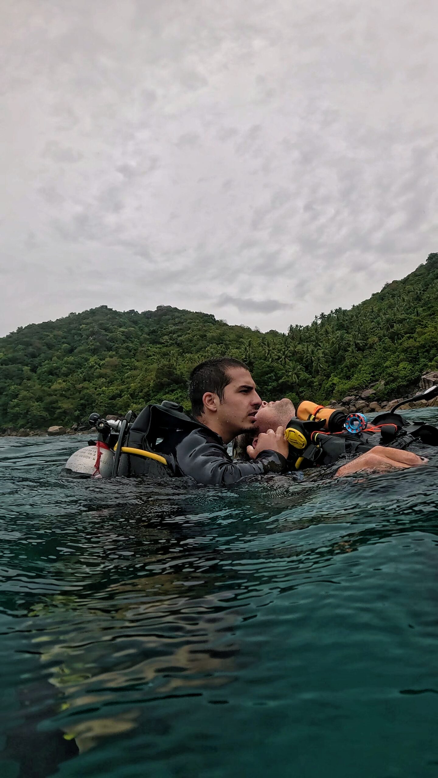 Rescue Diver student in Koh Tao checking if an unresponsive diver is breathing during surface water rescue training.