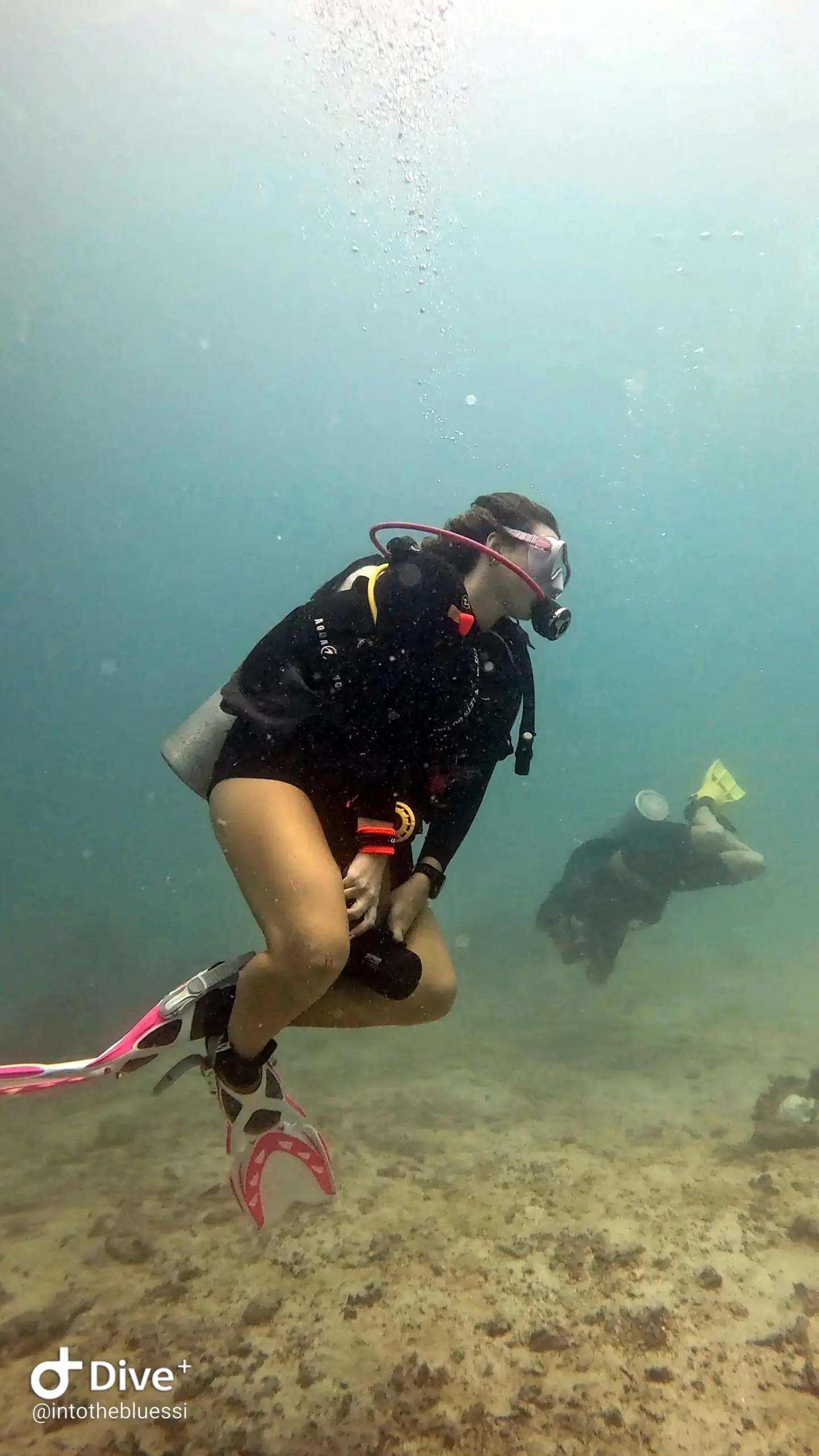 Scuba diver practicing with a DPV (underwater scooter) during a specialty dive course in Koh Tao, Thailand.