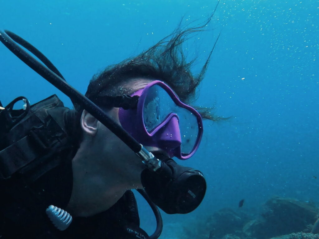 Scuba diver exploring coral reefs in Koh Tao, Thailand