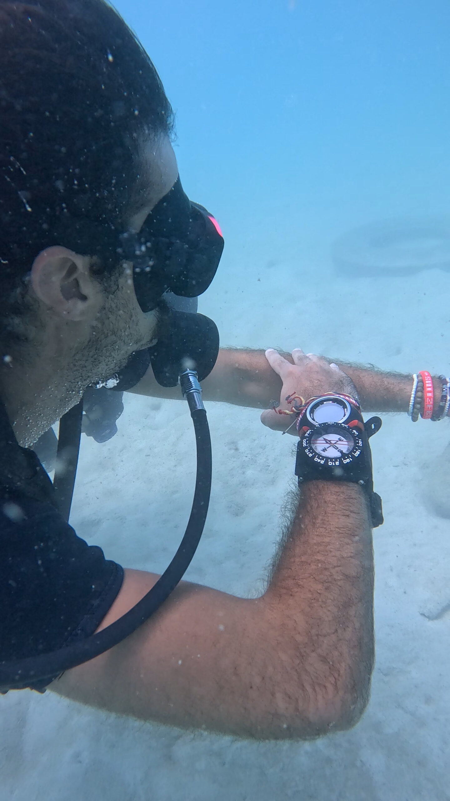 Scuba diver checking depth and air gauge underwater at Aow Leuk, Koh Tao – Dive In Koh Tao