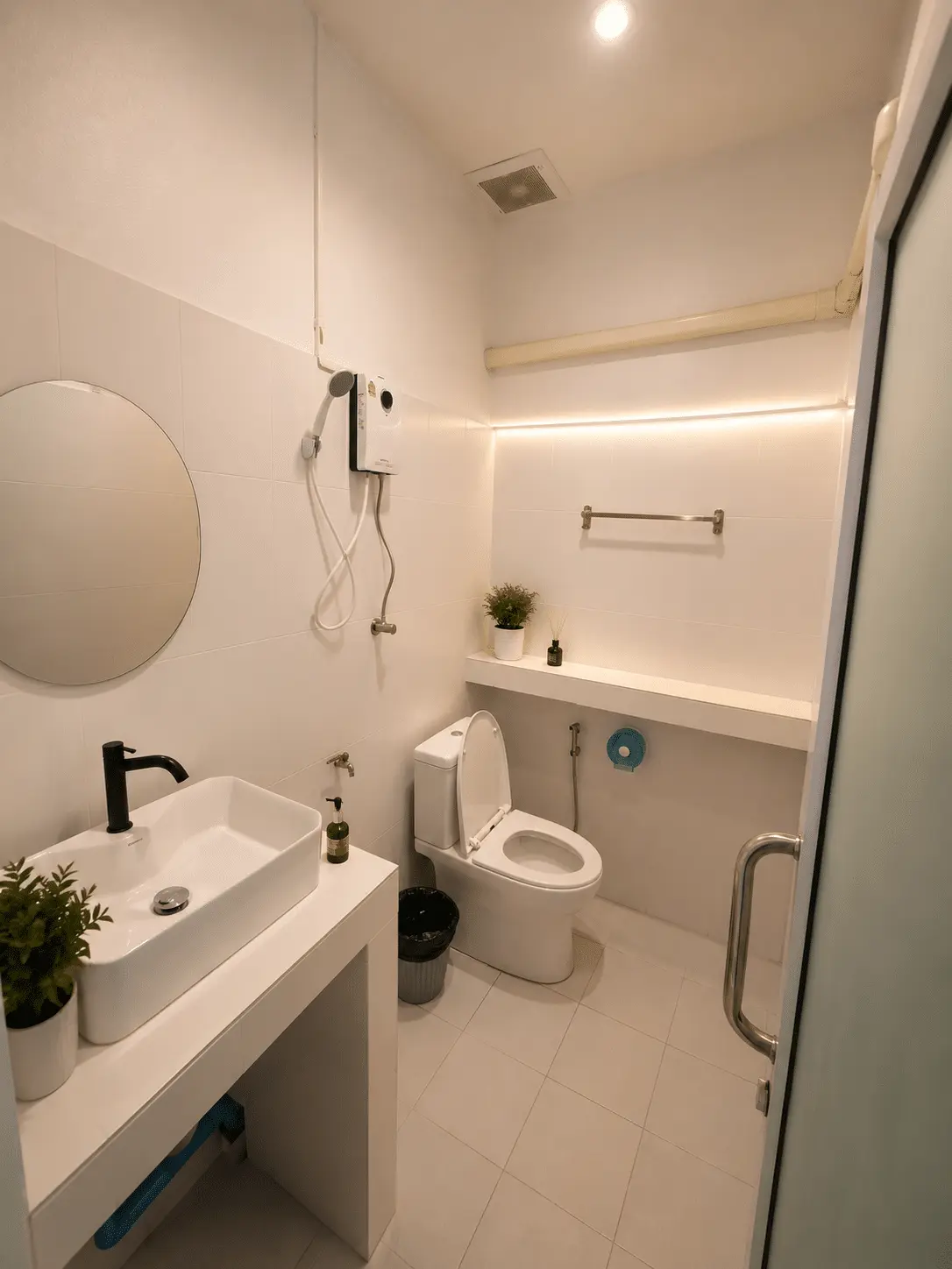 Modern white ensuite bathroom with shower, sink and toilet at Dive In Koh Tao accommodation in Koh Tao, Thailand.