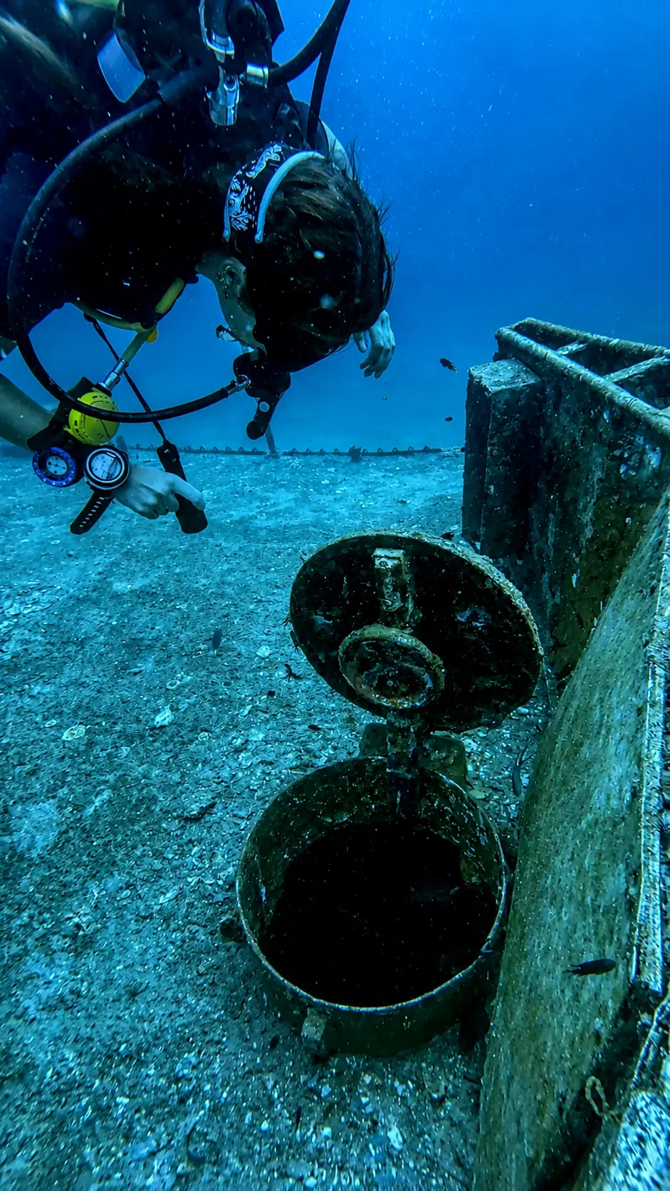 Scuba diver exploring a shipwreck during an SSI Wreck Diving specialty dive in Koh Tao, Thailand.